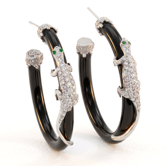 18K white gold lizard hoop earrings on black onyx with diamonds and green eyes, pair angled view