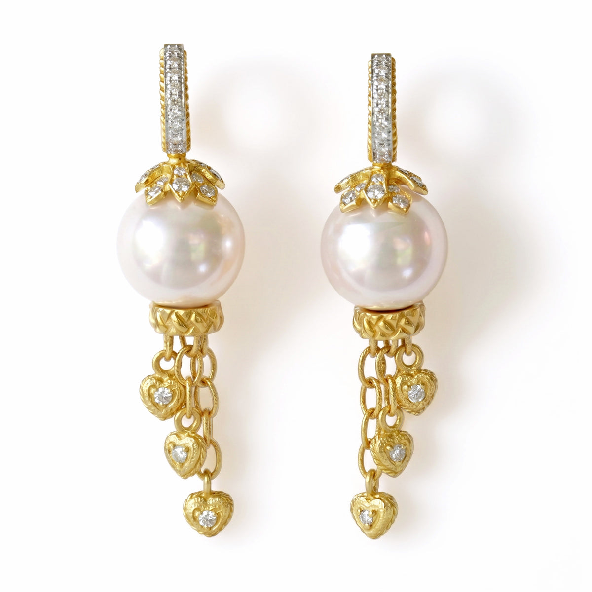 South Sea pearl and diamond dangling heart earrings in 18K yellow gold, pair shown together