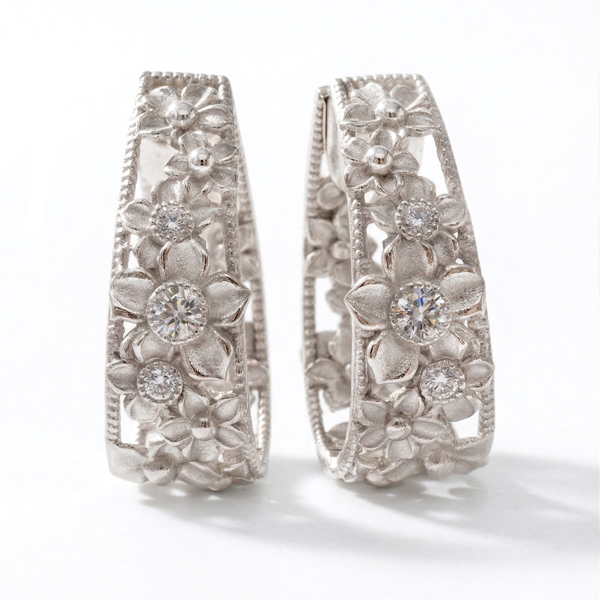 "Mayflower" 18K white gold diamond floral inside-out hoop earrings, pair shown together