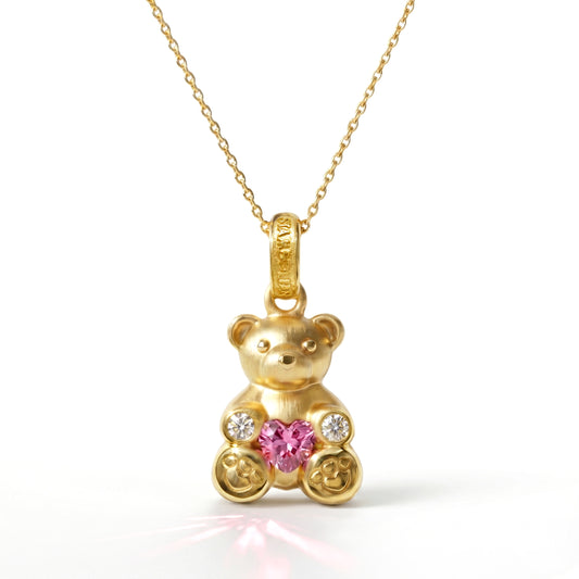 Teddy Bear charm pendant in 18K gold with diamonds and heart shape pink sapphire, front view on chain