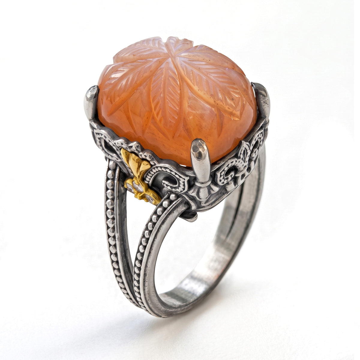 "Beginnings" aged silver and 18K gold ring with carved peach moonstone and diamond fleur de lis, angled view