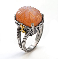 "Beginnings" aged silver and 18K gold ring with carved peach moonstone and diamond fleur de lis, angled view