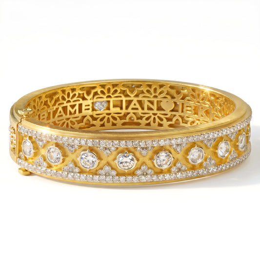 "Passion" 18K yellow gold and diamond bangle bracelet, front view with the signature diamond heart inside