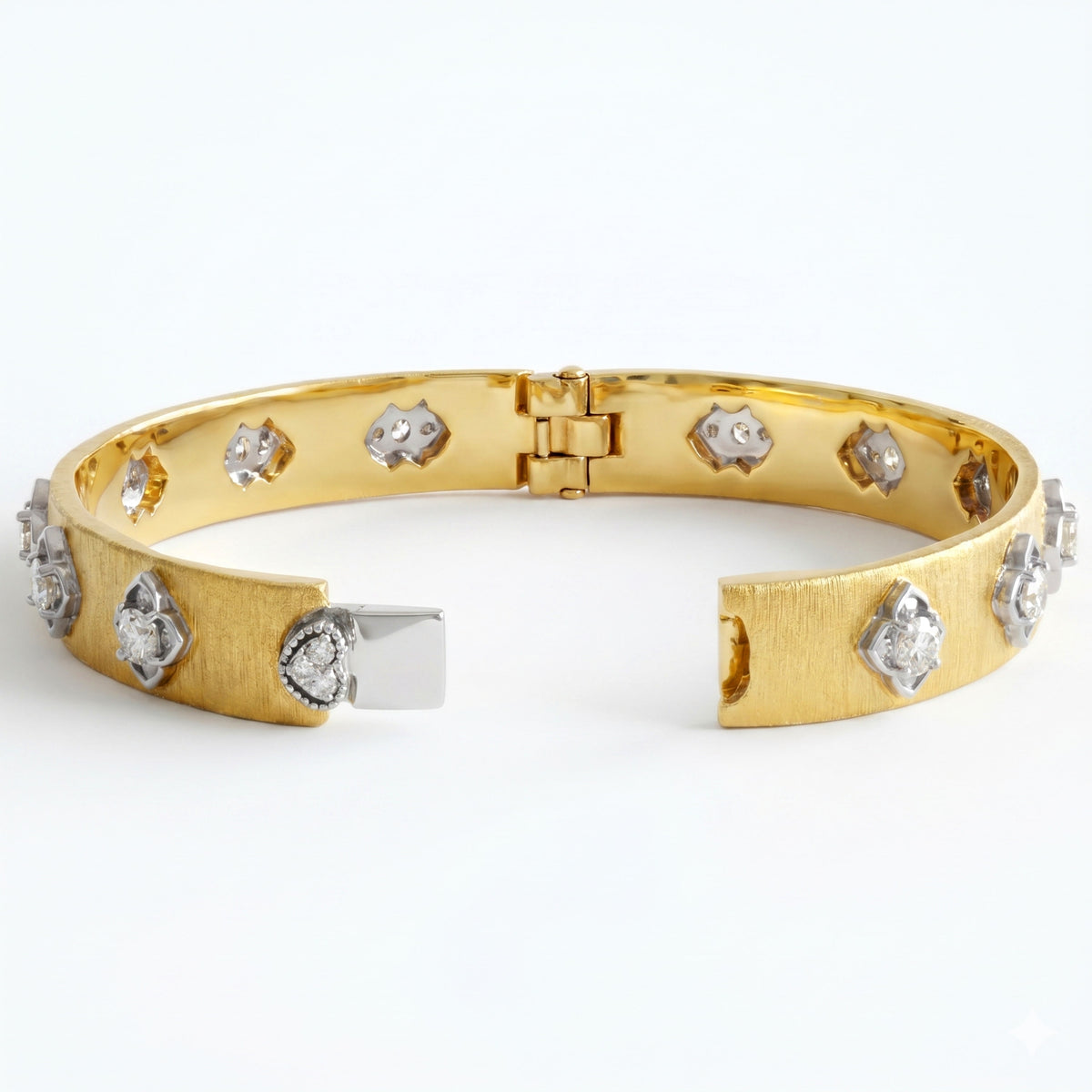 Floral diamond bangle in 18K yellow and white gold with brushed finish, shown open on its hinge