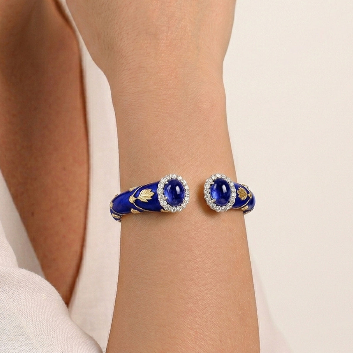 "Colors of Life" 18K gold cuff bracelet with cobalt blue enamel, tanzanite and diamonds, worn on the wrist