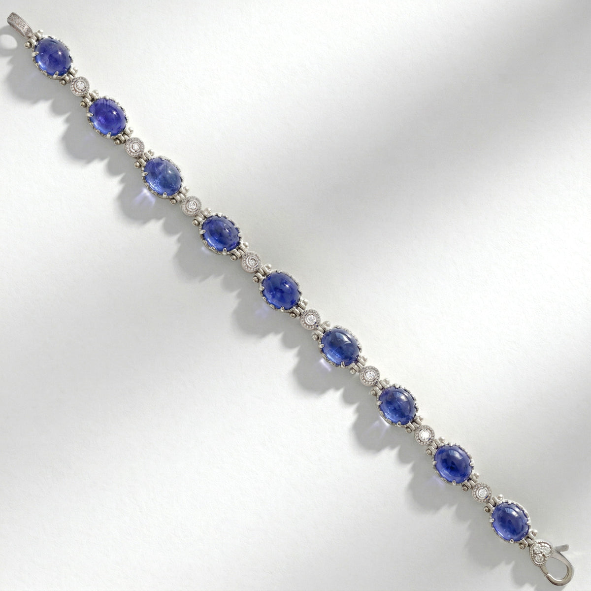Happiness tanzanite and diamond bracelet in 18K white gold, top-down view of nine stones