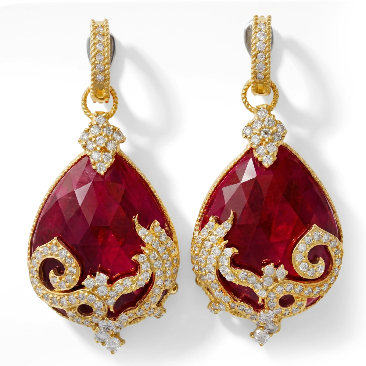18K gold earrings with pear shape ruby and diamond scrollwork, pair shown together, front view