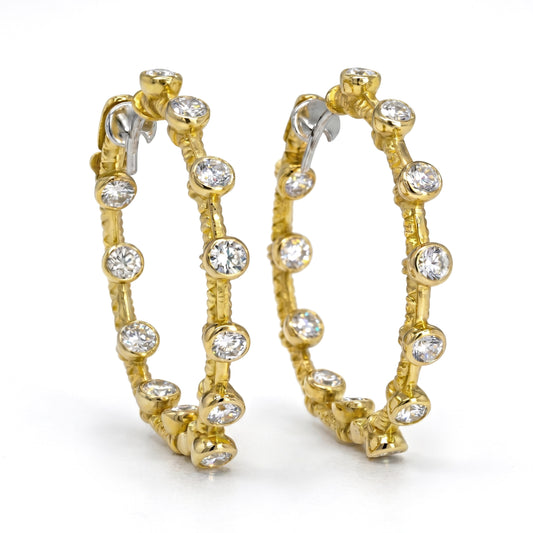 Diamond inside-out hoop earrings in 18K yellow gold with bezel set stones, pair shown together