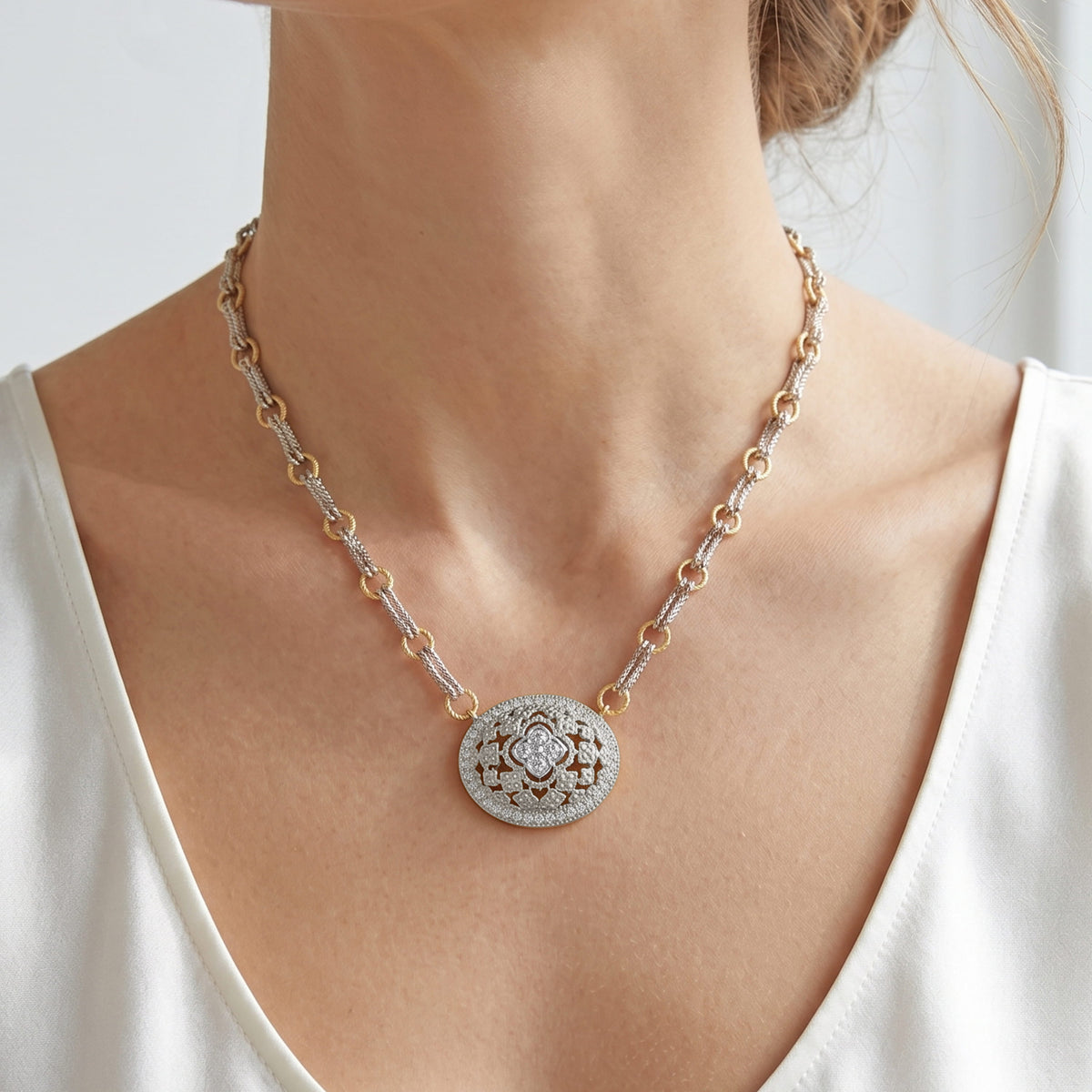 "Passion" 18K two-tone white and yellow gold oval diamond pendant necklace with double chain, on a model