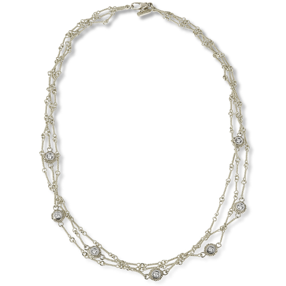18K white gold triple link chain necklace with seven double sided diamond bezels and clasp, top-down view