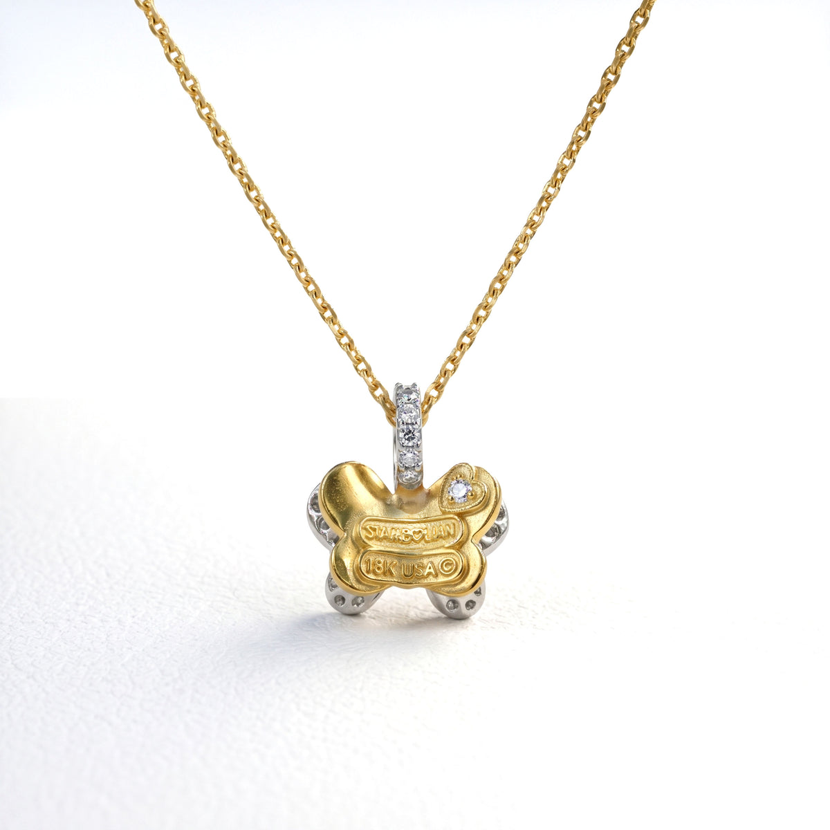 18K two-tone gold and diamond butterfly charm pendant, small size, back view showing the gold reverse and hallmark