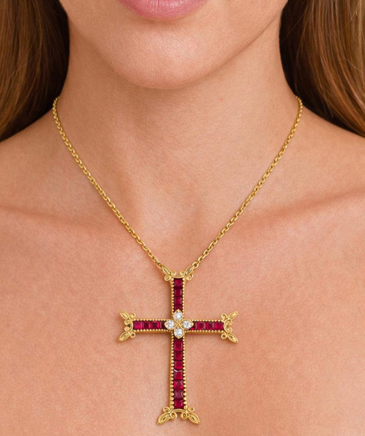 18K yellow gold cross pendant with rubies and diamonds on a gold chain, on a model
