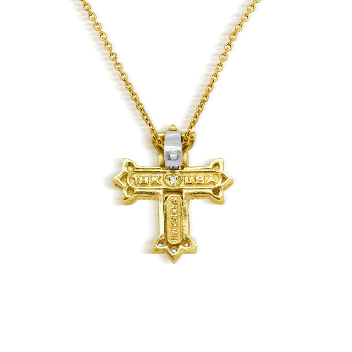 Two-tone 18K gold and diamond cross pendant on its chain, back view showing the signature diamond heart
