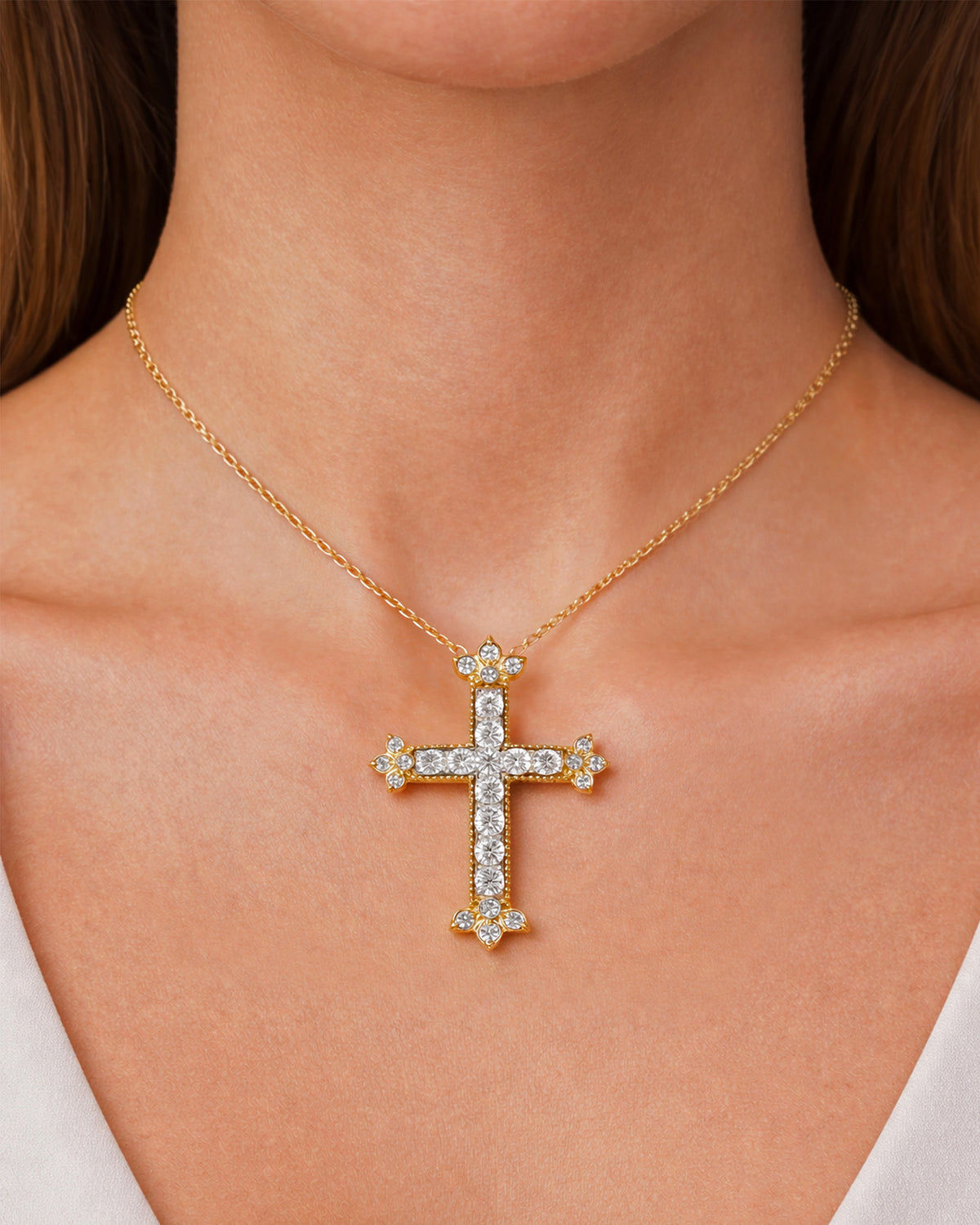 Medium cross pendant necklace in 18K yellow gold with diamonds, worn on a model