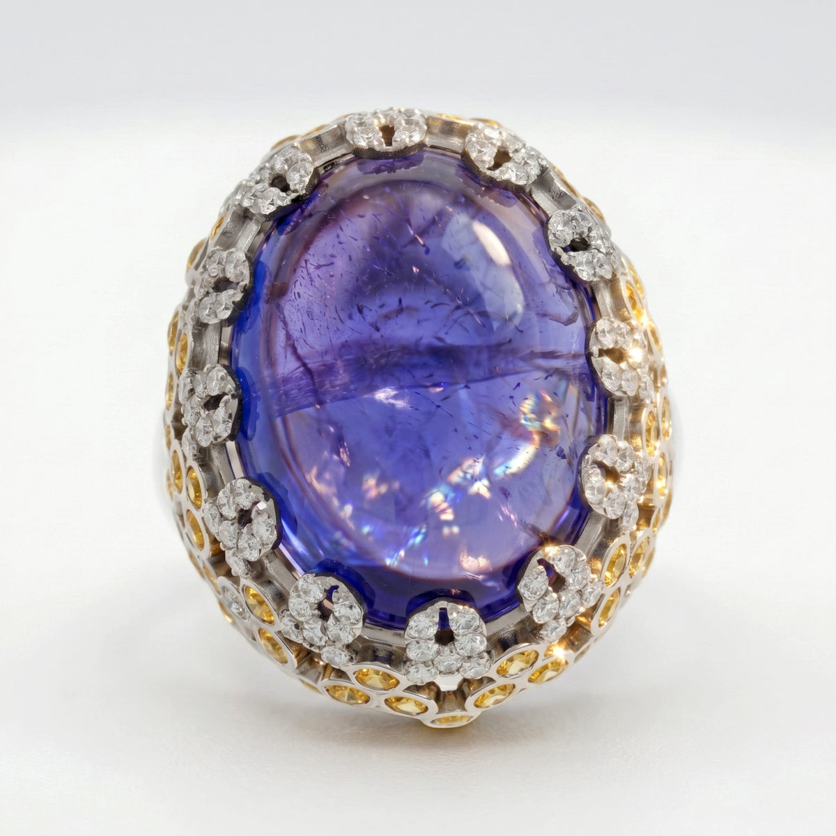 18K gold ring with cabochon tanzanite and diamond halo, front view