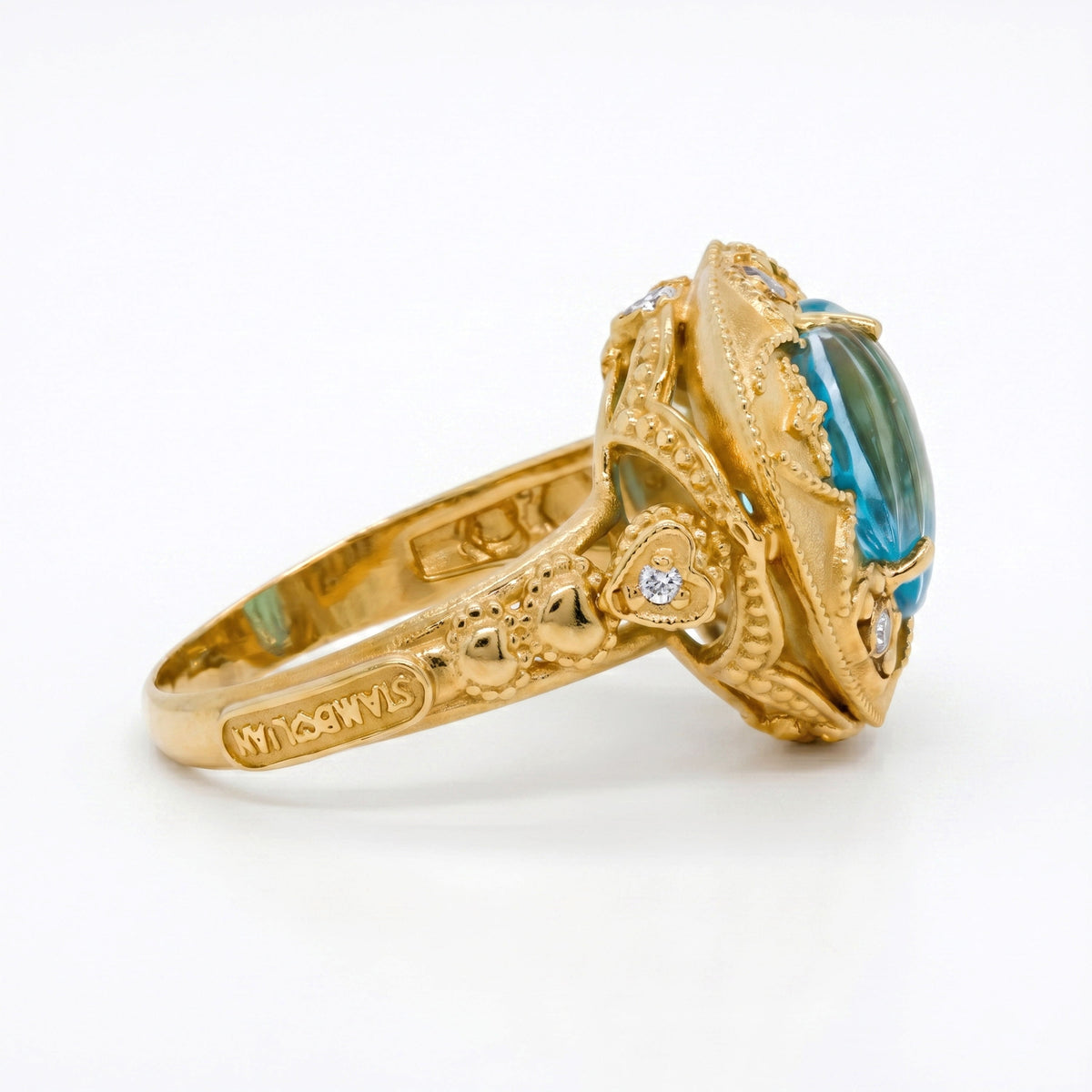 Candy heart blue topaz and diamond ring in 18K gold, side view of the shank and gallery