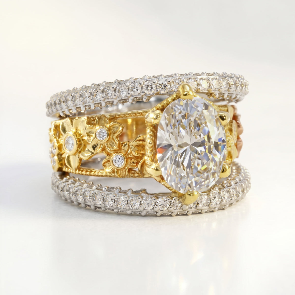 Mayflower oval diamond ring in 18K tri-color gold, front view of the floral band and diamond edges