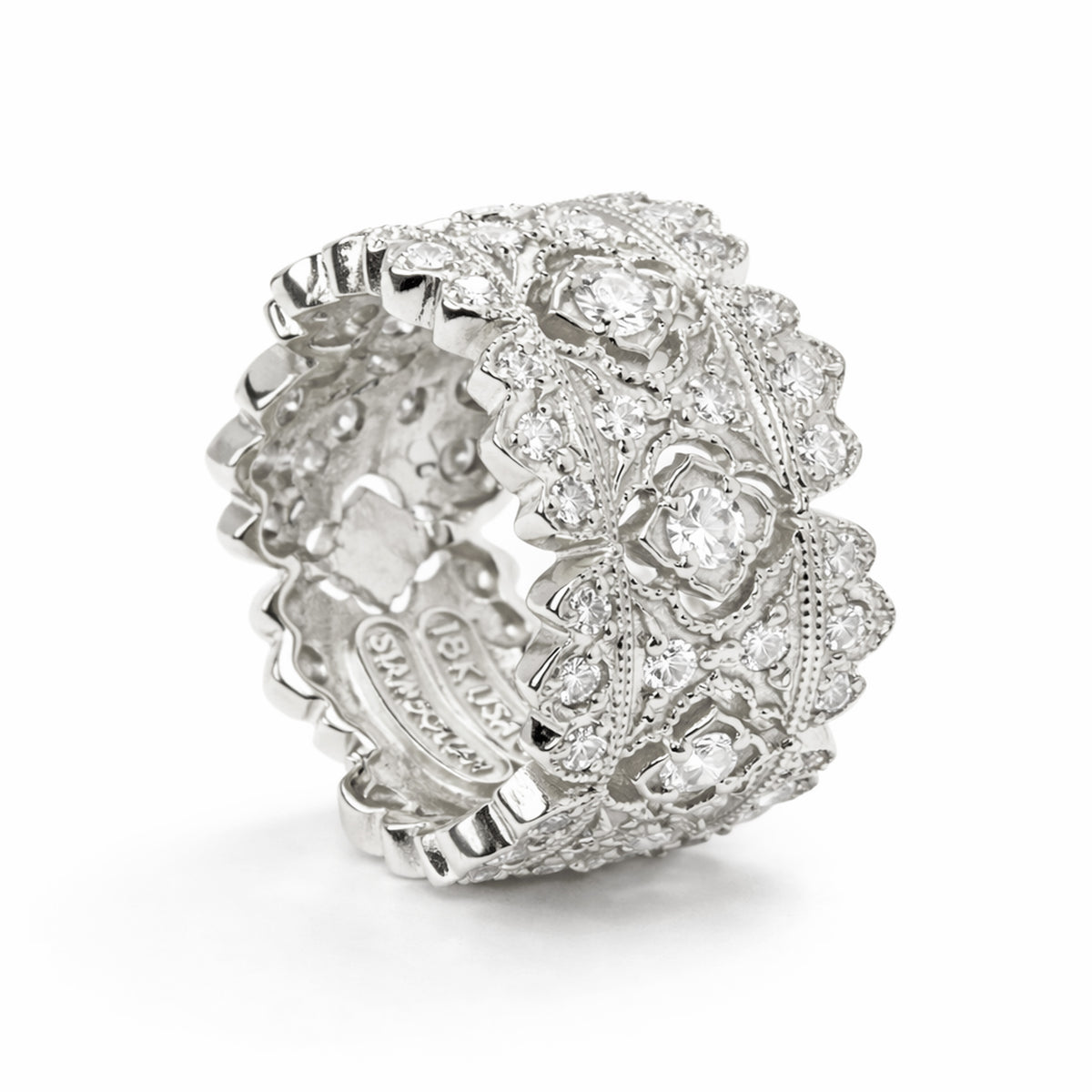 Passion diamond band ring in 18K white gold, angled view showing the inside of the band and signature