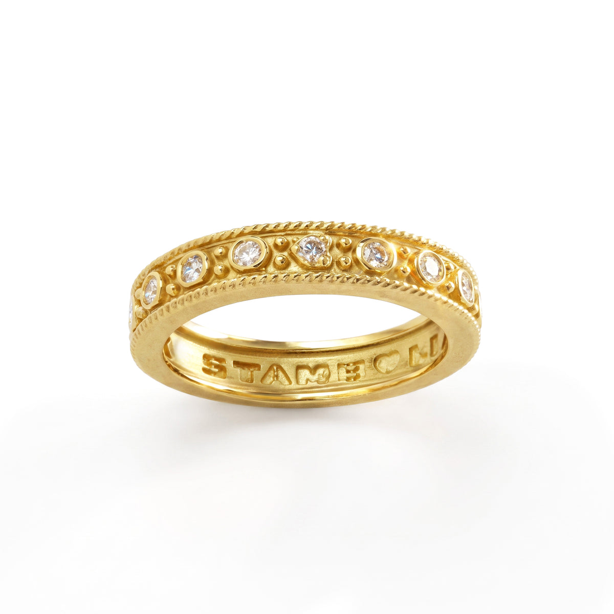 Stackable diamond band ring in 18K yellow gold with bezel-set diamonds, front view