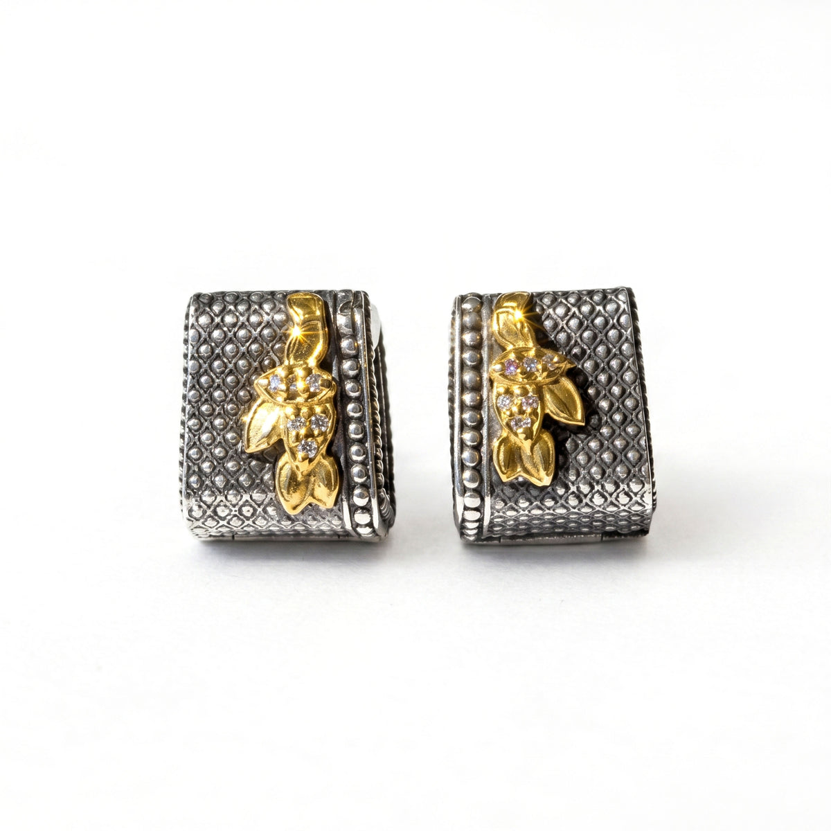"Beginnings" huggie earrings in aged silver and 18K gold with diamonds, pair shown together