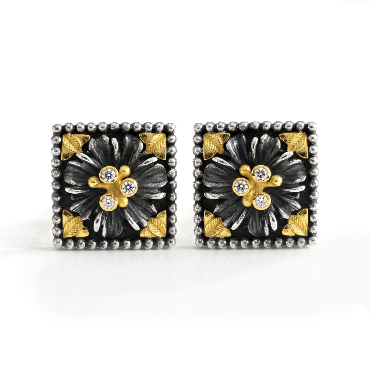 "Organza" diamond floral stud earrings in aged silver and 18K gold, front view of the pair