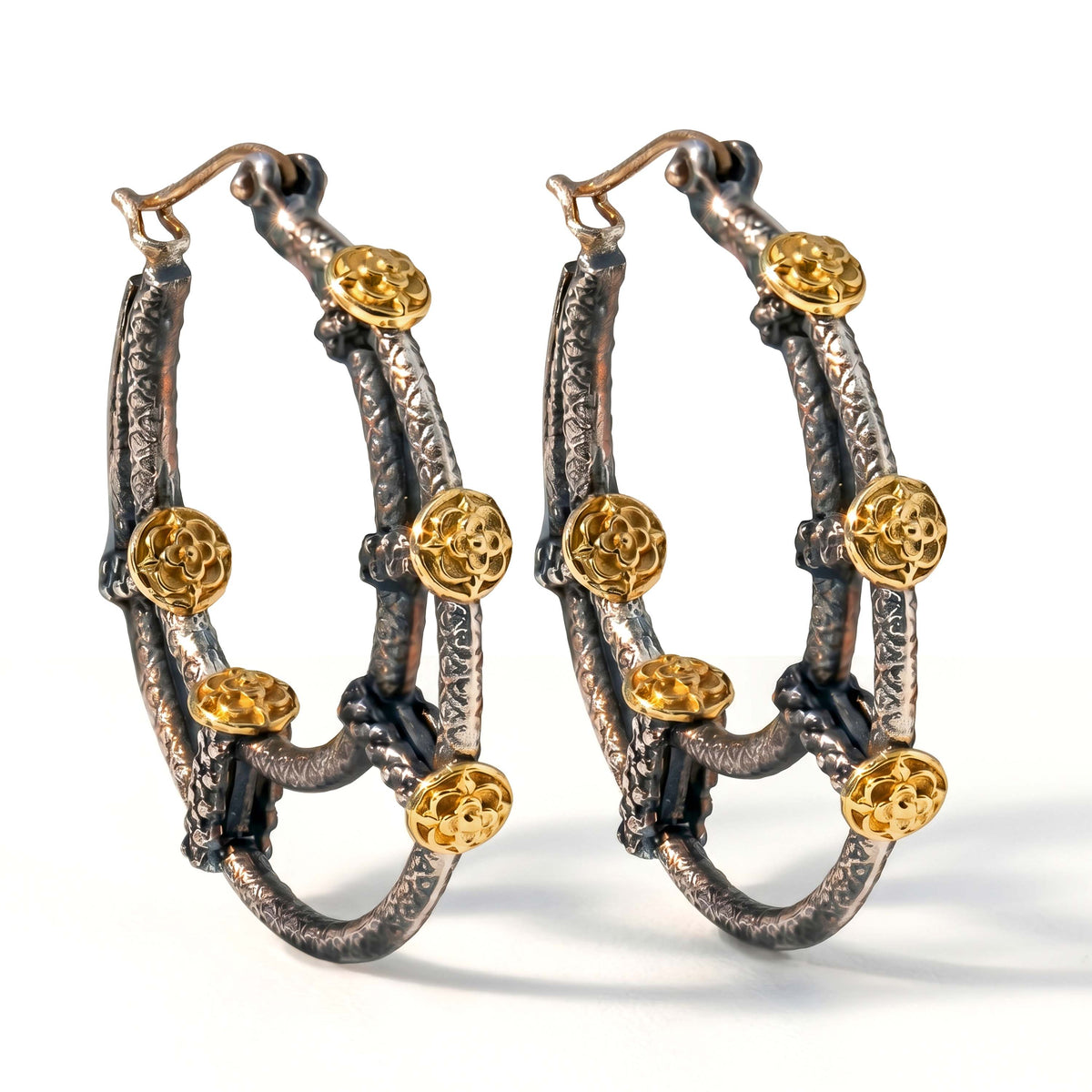 "Circle of Life" inside-out hoop earrings in aged silver and 18K gold, pair shown together