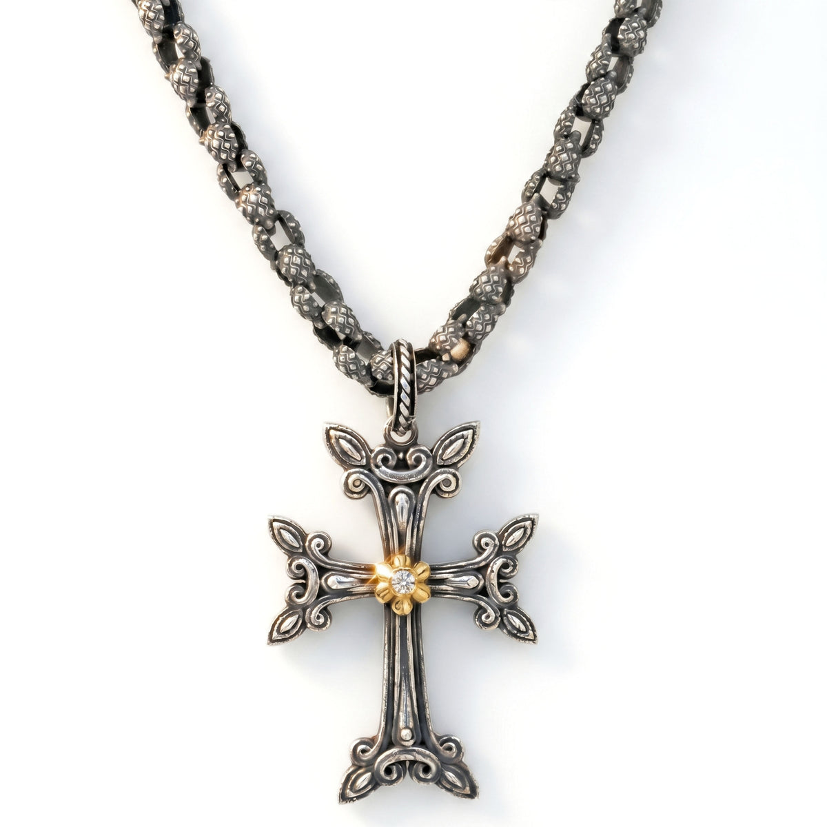 "Beginnings" Armenian cross pendant in aged silver and 18K gold with a diamond center, shown with its chain