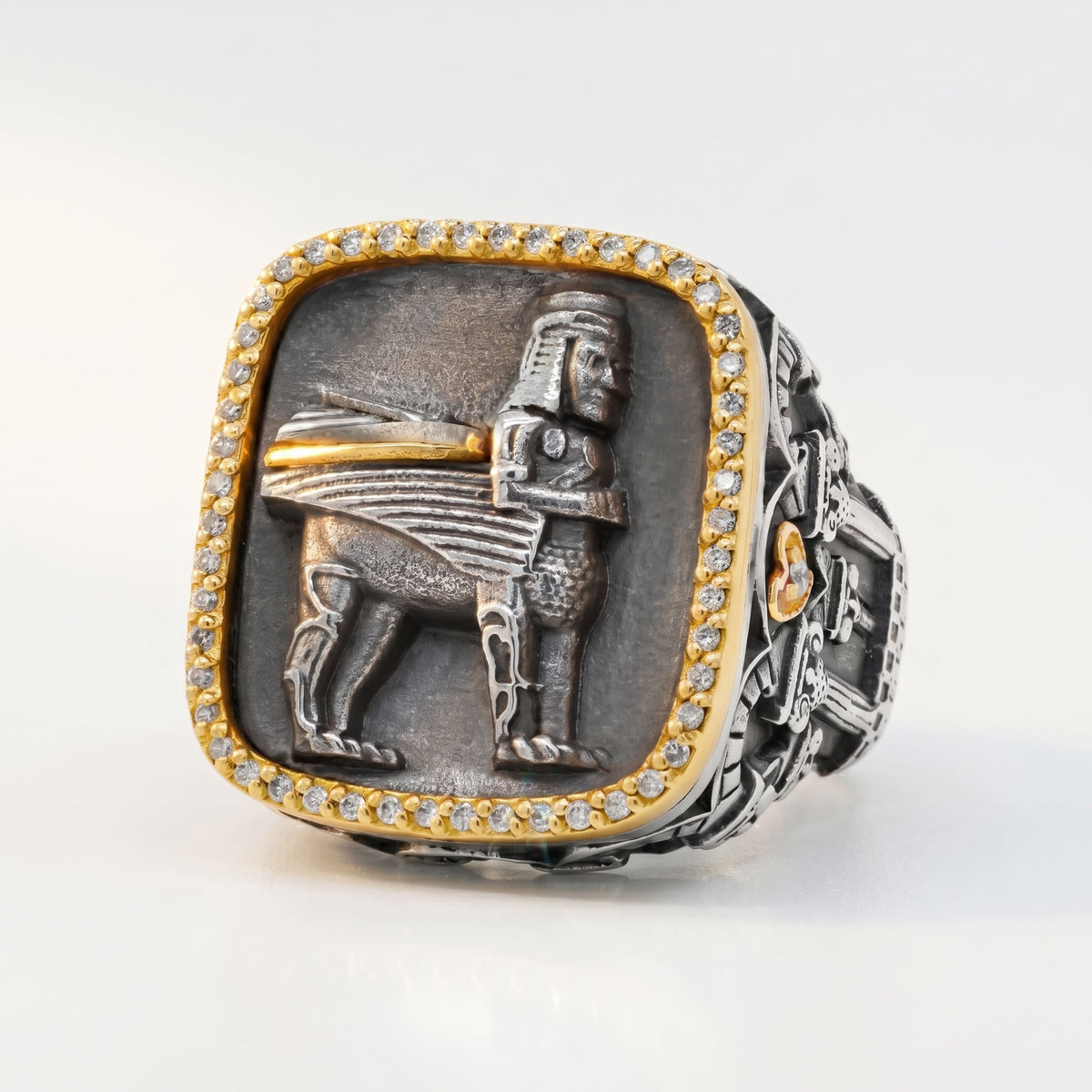 "Erebuni" men's ring in aged silver and 18K gold with diamond border, front view of the winged figure