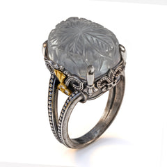 "Beginnings" aged silver and 18K gold ring with carved grey moonstone center and diamonds, angled view